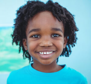 Close-up portrait of a smiling child in the St. Louis area.